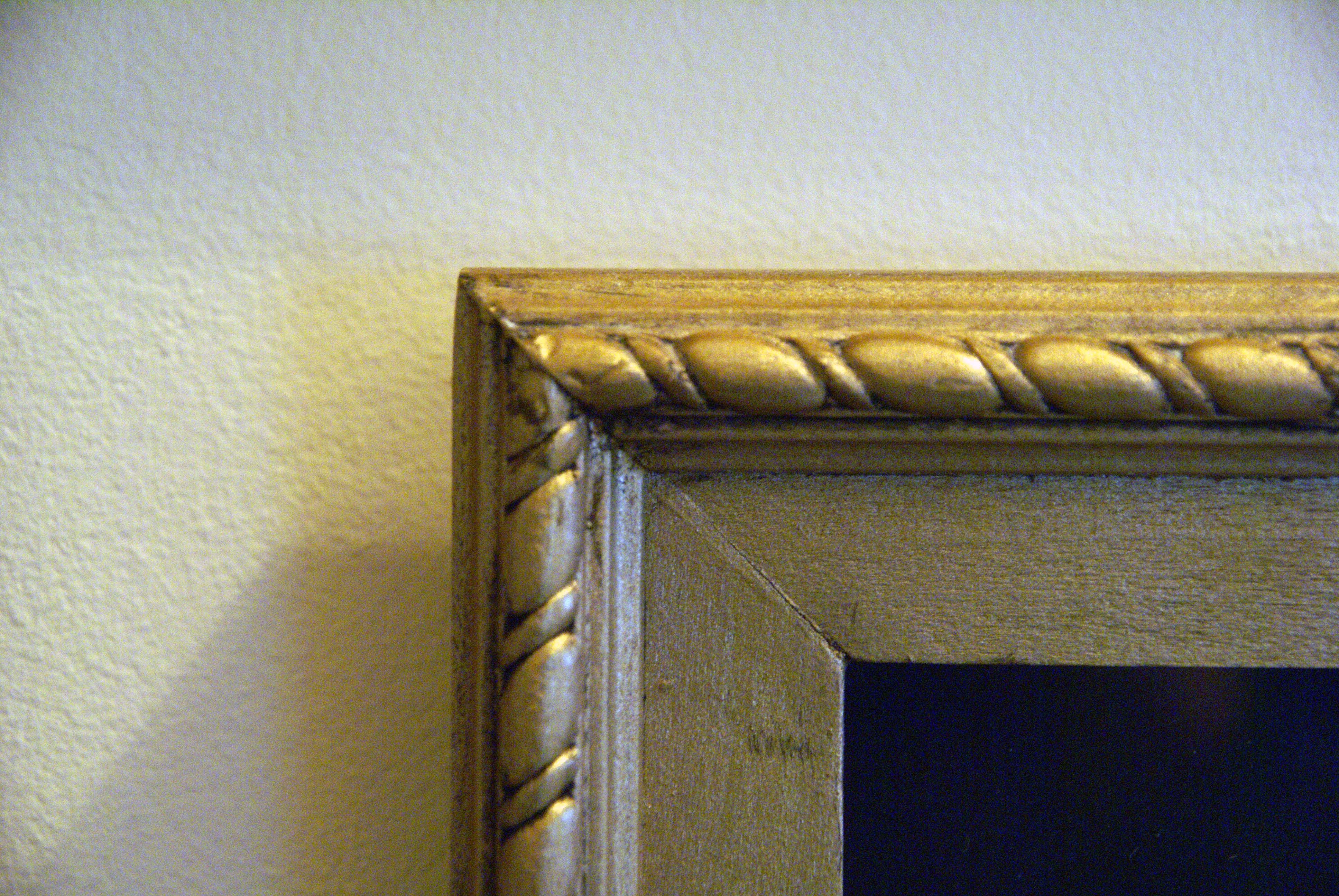 gold colored custom made frame with rope border